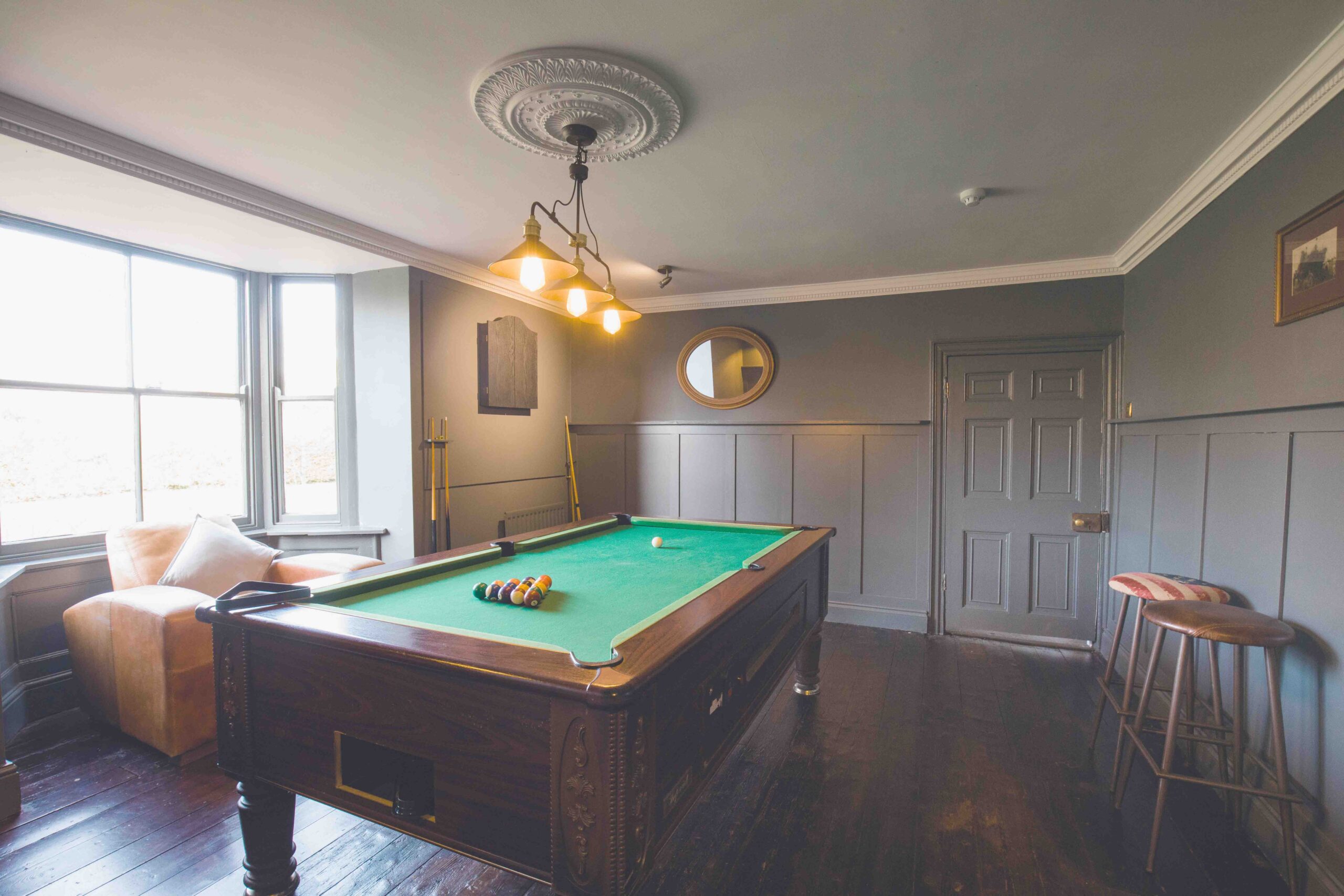 Spray painted games room in grey with snooker table.